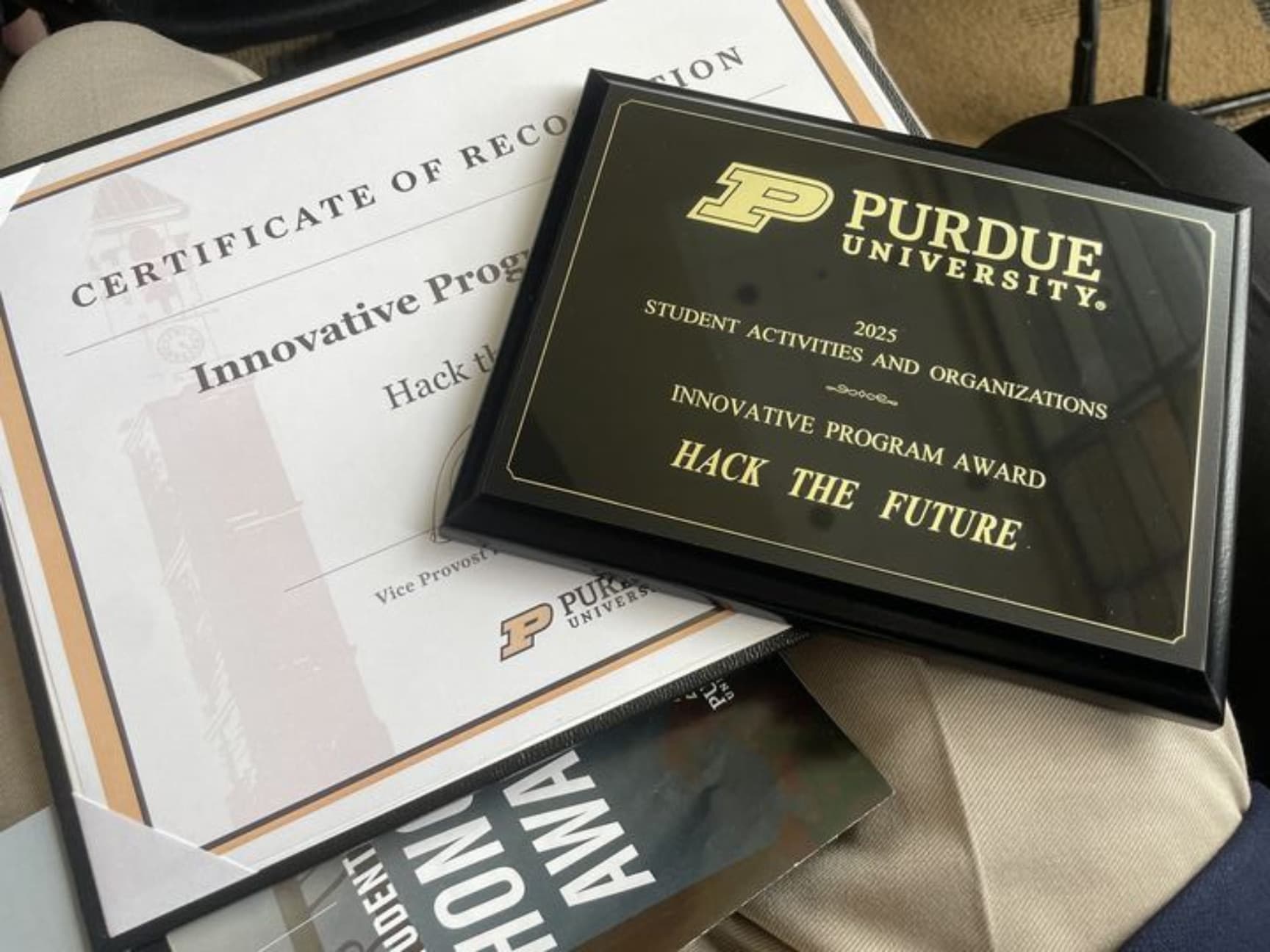 The Purdue University plaque for the 2025 Student Activities and Organizations Innovative Program Award, engraved Hack the Future, on its certificate of recognition